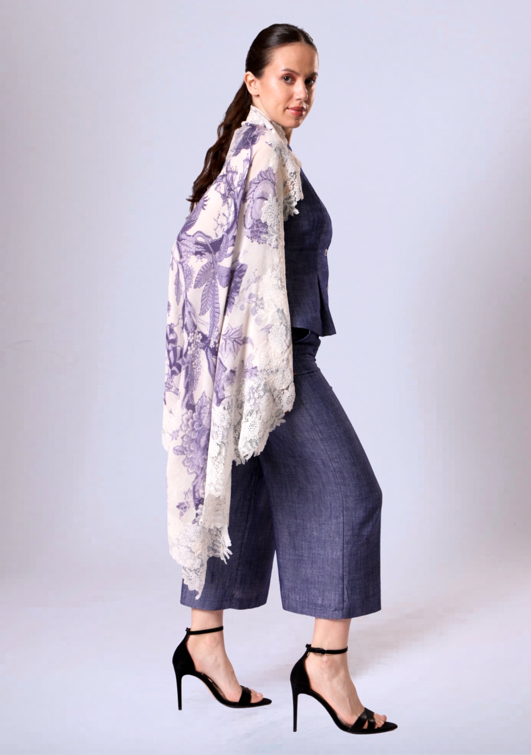 Woman wearing a Maneesha Ruia violet Jacobean-print wool-and-silk scarf with ivory lace, luxury designer floral scarf.