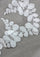 Close-up of white lace fabric with leaf patterns on a gray background