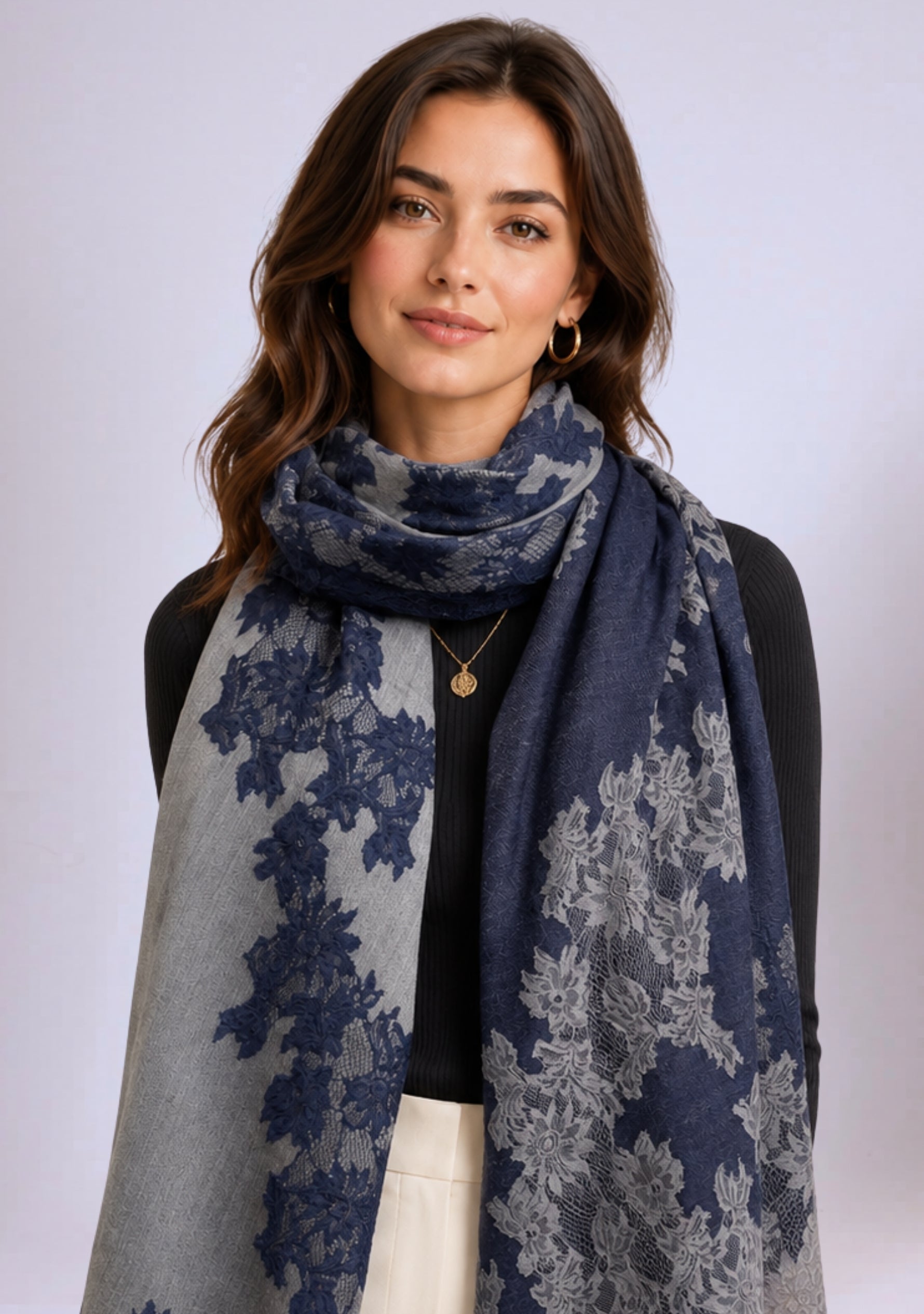 Woman wearing a blue and gray floral-patterned scarf on a white background