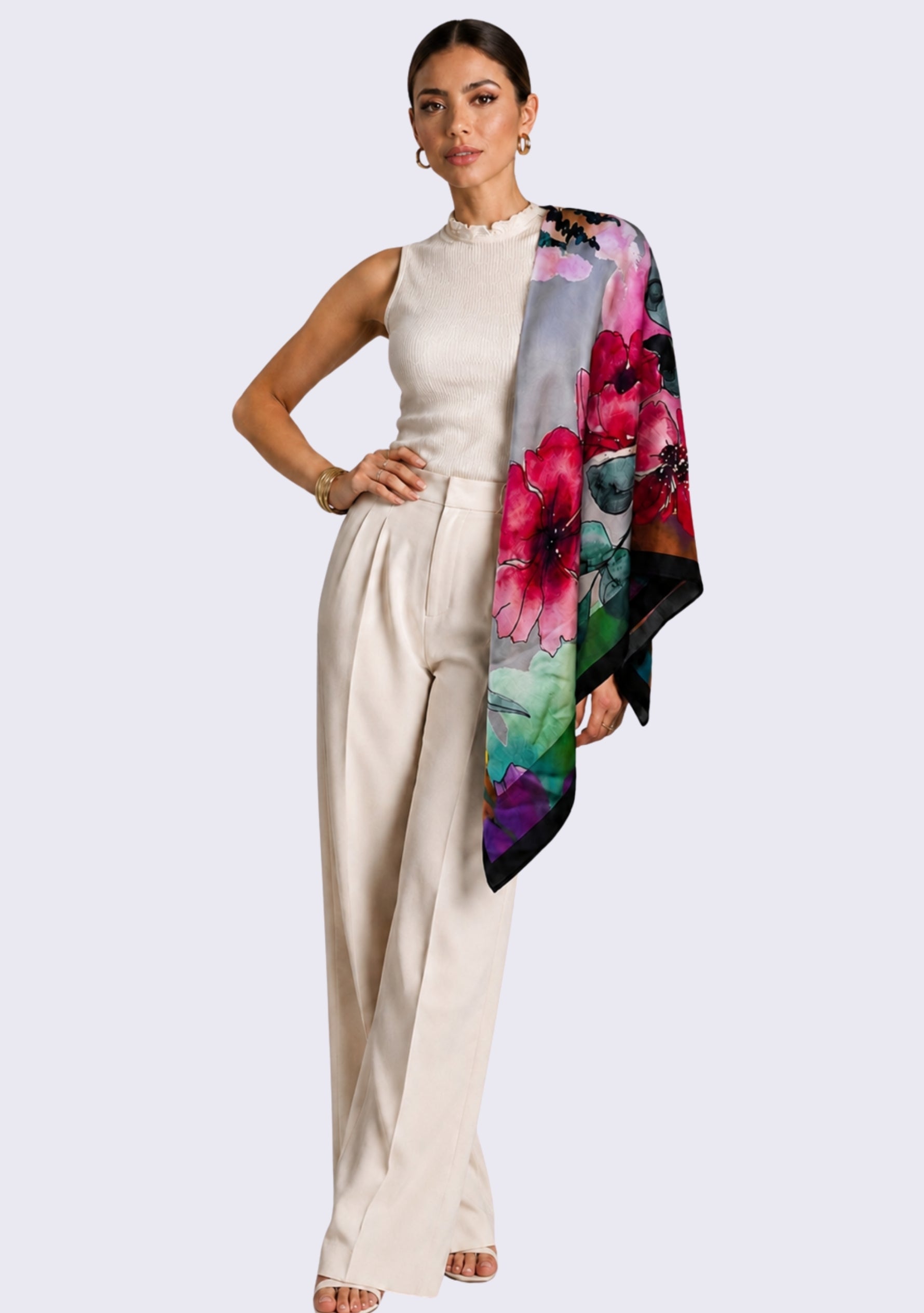 Maneesha Ruia Poppy Field Print Silk Twill Square Scarf with Gunmetal & Silver Swarovski Crystals styled as an elegant shoulder drape with an ivory sleeveless top and tailored trousers.