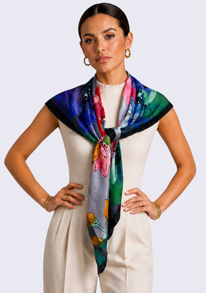 Maneesha Ruia Poppy Field Print Silk Twill Square Scarf with Gunmetal & Silver Swarovski Crystals styled as an elegant silk neck scarf with an ivory sleeveless top and tailored trousers.