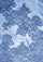 A close-up of a light blue fabric with an intricate dark blue floral lace pattern.