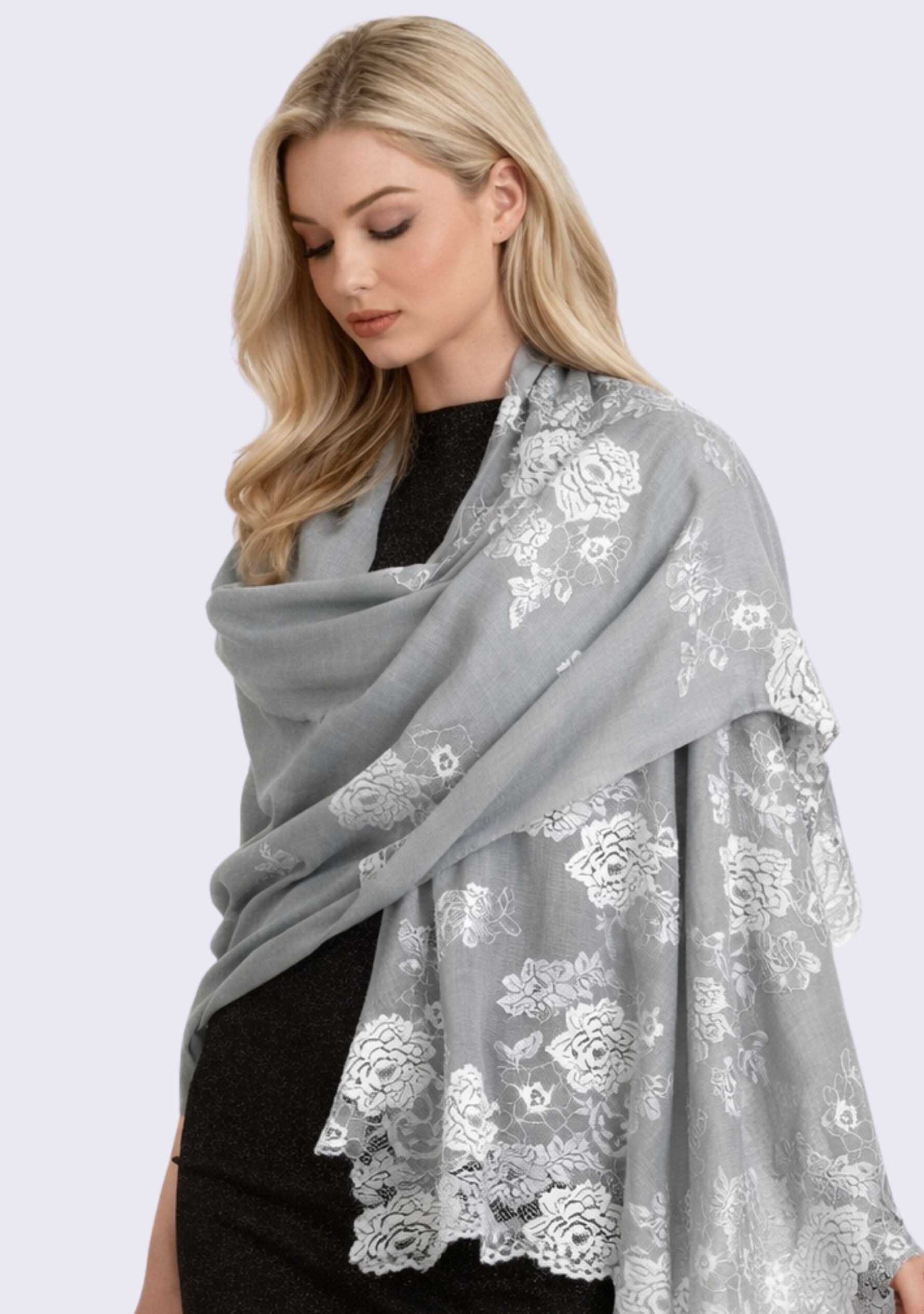 Luxury silver gray cashmere scarf with delicate light blue Chantilly floral lace, elegantly draped on a female model in a sleeveless dress. Soft, lightweight designer cashmere wrap with intricate handcrafted lace, perfect for weddings, evening wear, formal occasions, and timeless luxury styling.