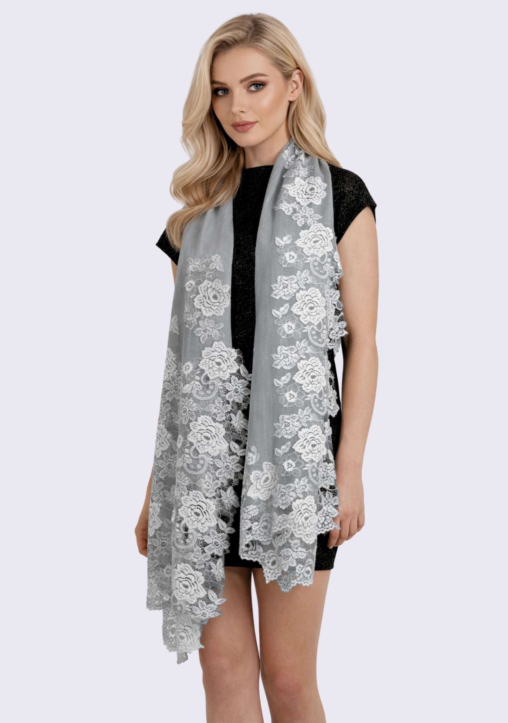 Luxury silver gray cashmere scarf with delicate light blue Chantilly floral lace, elegantly draped on a female model in a sleeveless dress. Soft, lightweight designer cashmere wrap with intricate handcrafted lace, perfect for weddings, evening wear, formal occasions, and timeless luxury styling.
