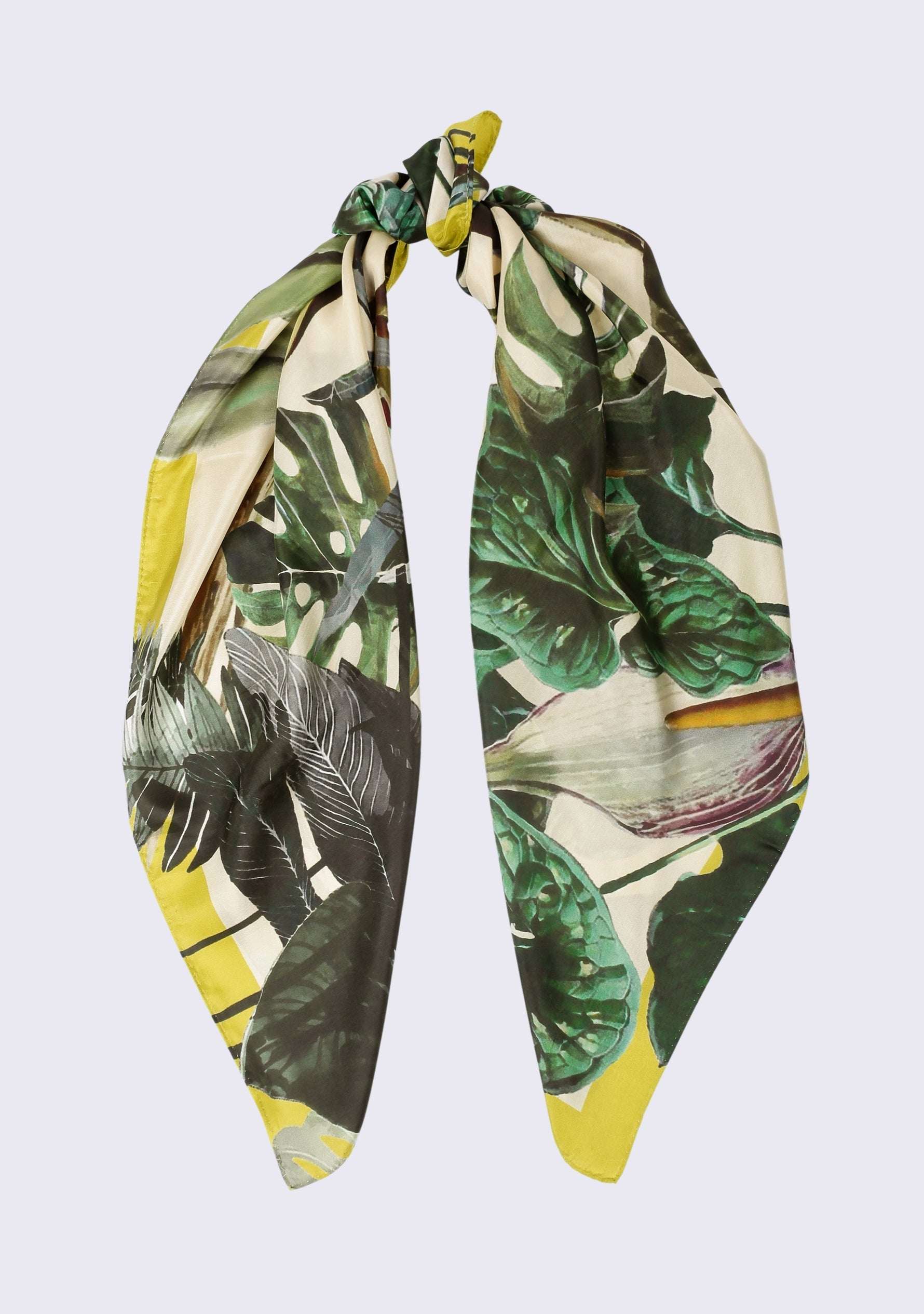 Toucan Print Silk Square Scarf by Maneesha Ruia styled in a graceful knot, showcasing lush emerald green tropical foliage, ivory tones, and vibrant lime green accents on luxurious 100% silk.